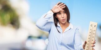 23 Effective Home Remedies for Heat Rash (Prickly Heat) in Adults and Babies Woman feeling hot during summer heat wave